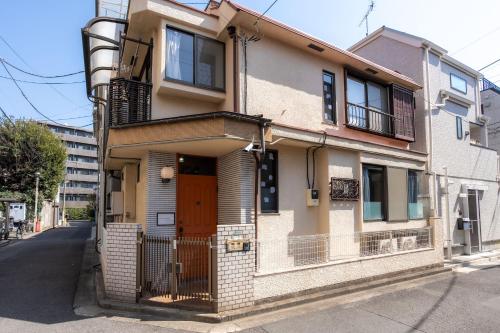 an apartment building with a door on a street at 3BR Entire House for7 #91Rated TraditionCozy Japanese Villa in Ikebukuro 6mins St in Tokyo