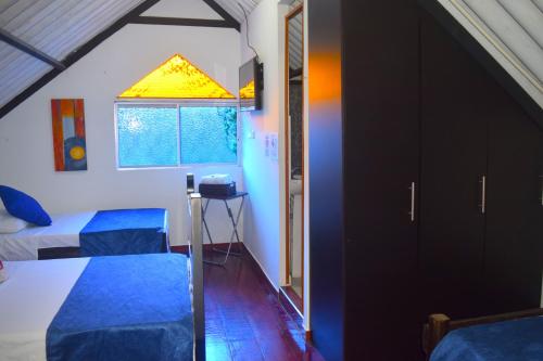 a small room with two beds and a window at FILANDIA HOTEL in Filandia