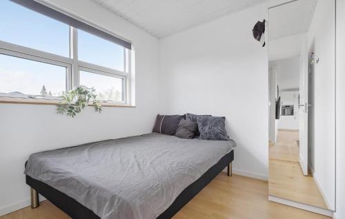 a bedroom with a bed and a large window at Stunning Home In Holbæk With Kitchen in Holbæk