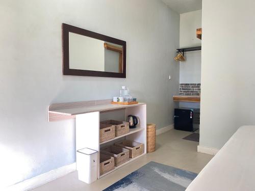 a bathroom with a counter with a mirror on the wall at Marta House gili air in Tanjungkarang