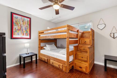 a bedroom with a bunk bed and a ceiling fan at Spacious 4 bedroom with pool-Minutes to Seaworld and lackland AFB in San Antonio