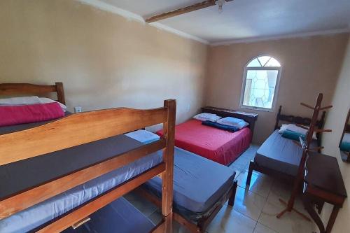 En eller flere senge i et værelse på Chácara Urbana Quiosque Canto do Curió