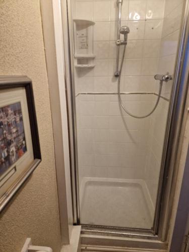 a shower in a bathroom with a glass door at Winston House in Bridlington