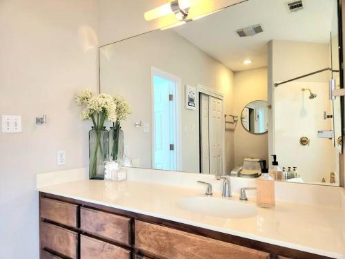 a bathroom with a sink and a large mirror at A Rare Find! - Bright & Gorgeous Lake Home in Marble Falls in Marble Falls