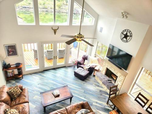 a person sitting in a living room with a fireplace at A Rare Find! - Bright & Gorgeous Lake Home in Marble Falls in Marble Falls