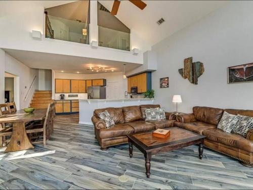 a living room with a couch and a table at A Rare Find! - Bright & Gorgeous Lake Home in Marble Falls in Marble Falls