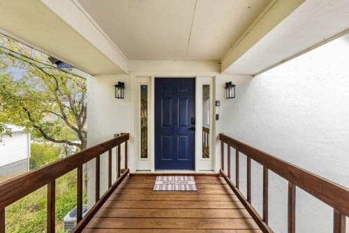 a porch with a blue door on a house at A Rare Find! - Bright & Gorgeous Lake Home in Marble Falls in Marble Falls