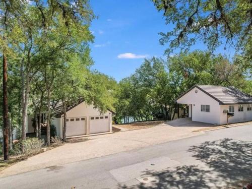 a house with a garage and a driveway at A Rare Find! - Bright & Gorgeous Lake Home in Marble Falls in Marble Falls
