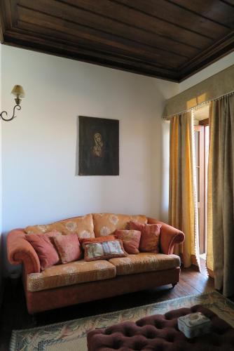 a living room with a brown couch in a room at Solar de Santa Maria in Bragança