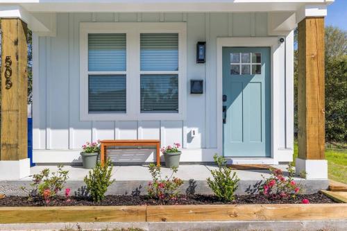 a house with a blue door and a bench at New•Downtown• OneTreeHill Bridge in Wilmington