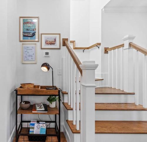 a staircase with white walls and wooden floors and a stair case at New•Downtown• OneTreeHill Bridge in Wilmington
