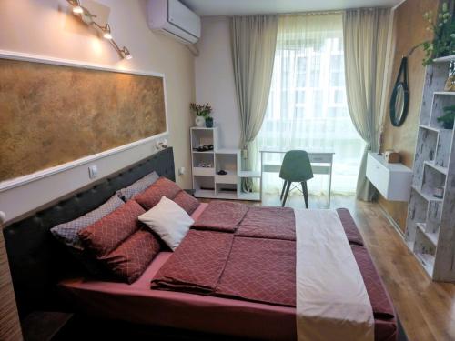 a bedroom with a bed and a large window at Уютен апартамент близо до морето IGROEG in Burgas City