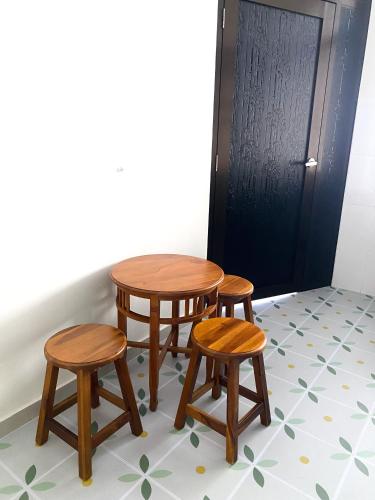 a table and four stools in front of a door at 5BR5B in Skudai, 15mins to UTM&Sutera, 7-16pax, WiFi in Skudai