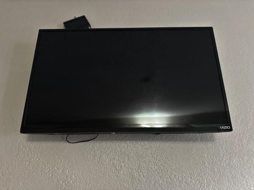 a flat screen tv sitting on a wall at Hotel Galaxy in Las Vegas