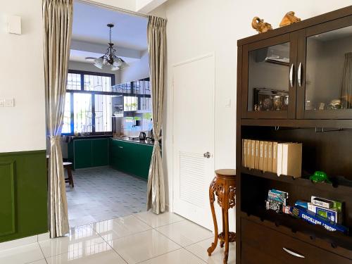 a kitchen with green and white walls and a window at 5BR5B in Skudai, 15mins to UTM&Sutera, 7-16pax, WiFi in Skudai