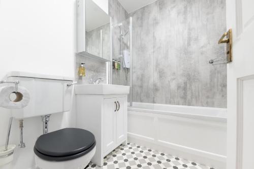 a bathroom with a black toilet and a shower at Old Edinburgh Court in Inverness