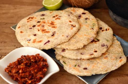 three naan breads on a table with a bowl of salsa at YALA FAMILY HOMESTAY in Tissamaharama