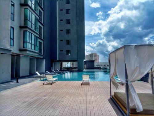 a swimming pool on the roof of a building at Jazz Suites Seaview with Bathtub - 2901 in Tanjong Tokong