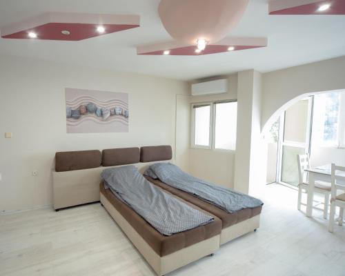 a bedroom with a large bed and a table at Aleksapart in Burgas City