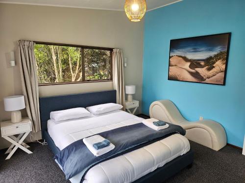 a bedroom with a large bed and a window at Catlins area accommodation in Owaka
