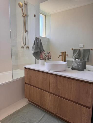 a bathroom with a sink and a shower at Penthouse with private Rooftop on the Broadwater in Gold Coast