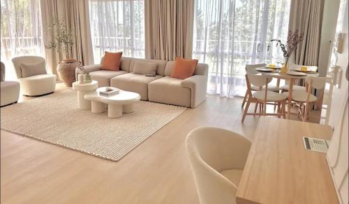 a living room with a couch and a table at Penthouse with private Rooftop on the Broadwater in Gold Coast