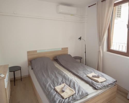 a bedroom with a bed with two towels on it at Aleks Top Center 2- Free parking in Burgas City