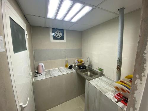 a small kitchen with a sink and a sink at Al Rahba Holiday Farmhouse in Al Rahba