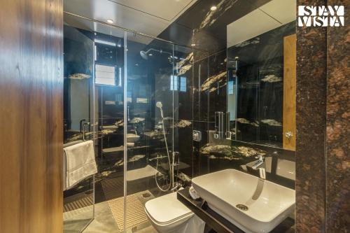 a bathroom with a sink and a shower at StayVistas Nyra Farms - Hill-view villa with Pool, Indoor & Outdoor games, & Lawn with Gazebo in Wada