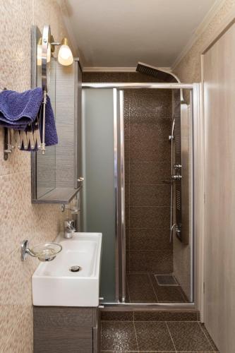 a bathroom with a shower and a white sink at Afroditi in Rethymno Town