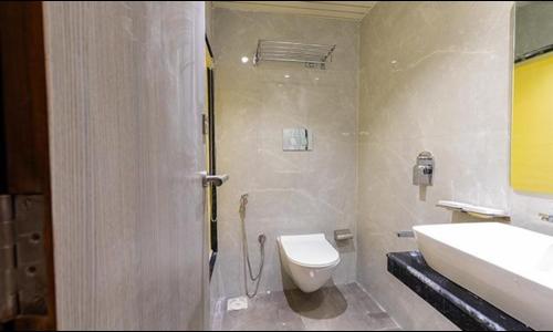 a bathroom with a toilet and a sink at FabHotel Green House in Mumbai