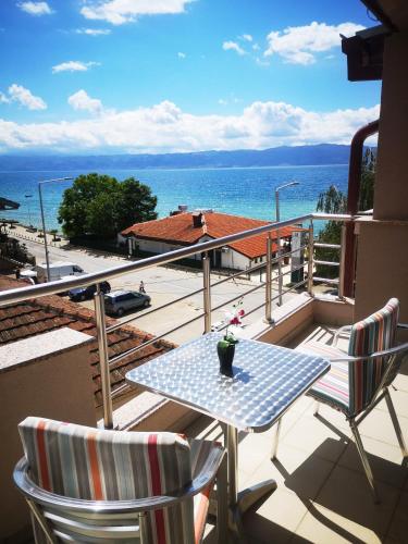 a balcony with a table and chairs and the ocean at Villa Nika in Peštani