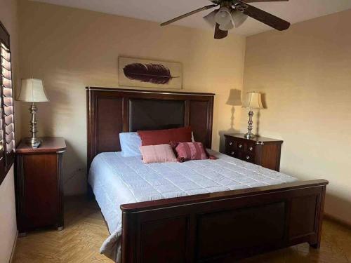 a bedroom with a large bed with two night stands at Casa Maya in Mexicali