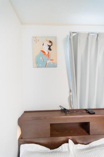 a bedroom with a bed with a wooden table at Tokyo Private House 大塚の宿 in Tokyo