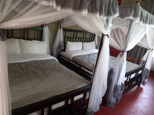 A bed or beds in a room at The Leopold Machakosi
