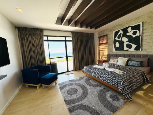 a bedroom with a bed and a large window at Villa Amihan in Puerto Galera