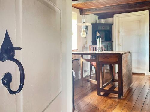 a kitchen with a black cat hanging on the door at 6 person holiday home in DEGEBERGA in Degeberga