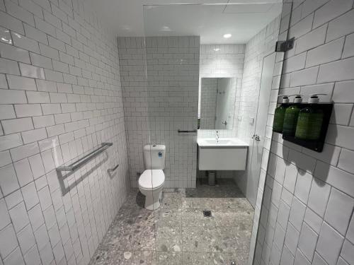 a bathroom with a toilet and a sink at Mortdale Hotel in Mortdale