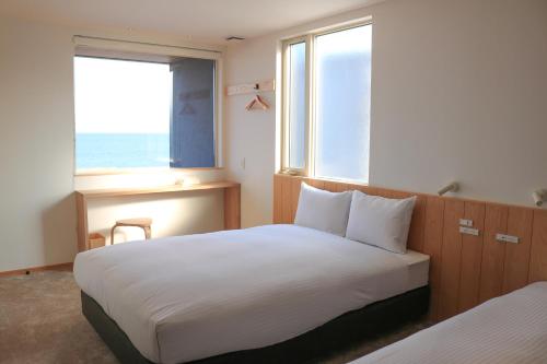 Ein Bett oder Betten in einem Zimmer der Unterkunft 瀬戸内 TABITO