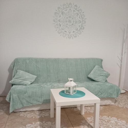 ein Wohnzimmer mit einem grünen Sofa und einem Tisch in der Unterkunft KRK stop in Cholerzyn