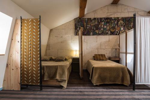 Postel nebo postele na pokoji v ubytování Les Jardins suspendus