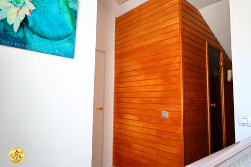 a wooden door in a room with a staircase at A4J Luxury in Mijas