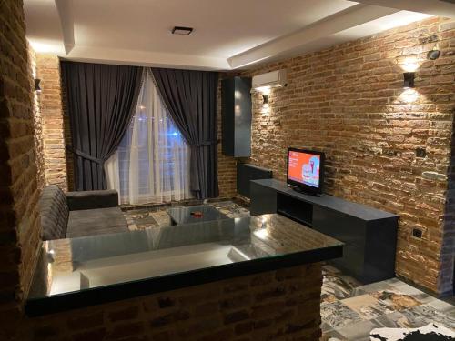 a living room with a large kitchen with a television at Tüyap Fair Elit Home in Istanbul