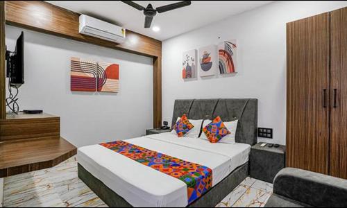 a bedroom with a bed and a television in it at FabHotel Fortune in Surat