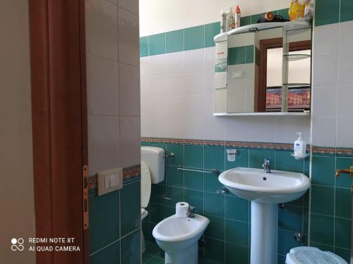 a bathroom with a sink and a toilet at Villa Antonella in Noto Marina