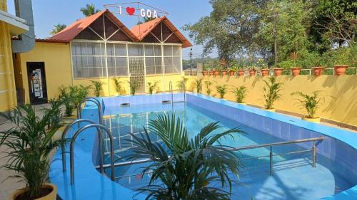 a pool in front of a building with plants at GLEN RESIDENCY in Dramapur