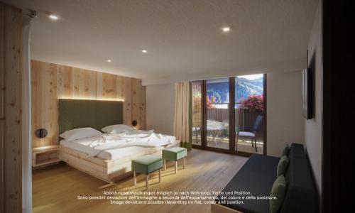 a bedroom with a bed and a large window at Chalet Rudla in Sesto