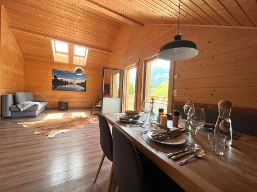 a dining room with a long table in a wooden room at Bergchalet Raffalt in Rohrmoos