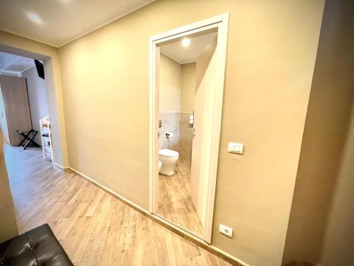 a mirror in a bathroom with a toilet in it at Golden House-Super View On Turin in Turin