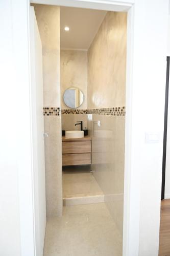 a bathroom with a shower with a sink and a mirror at Perla Marina 2 Acitrezza in Acitrezza